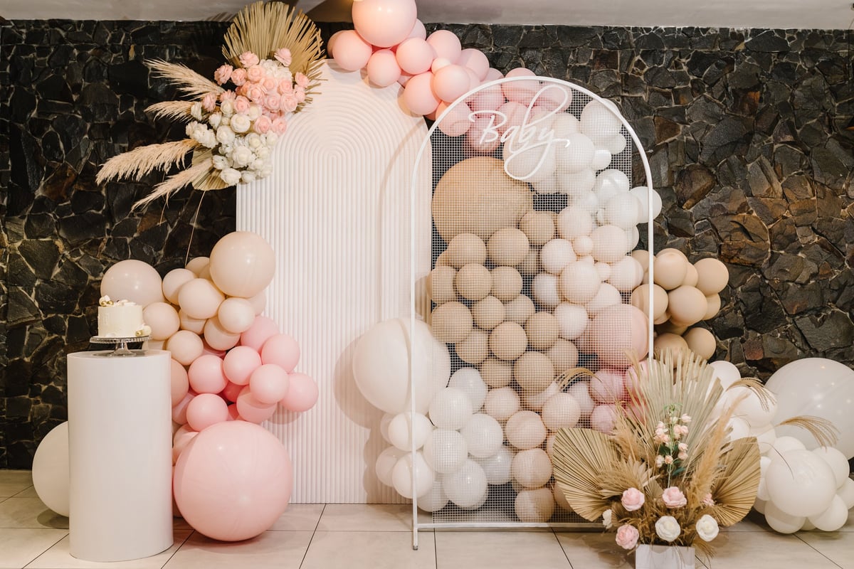 Beautiful balloon arch and floral backdrop for party celebrations