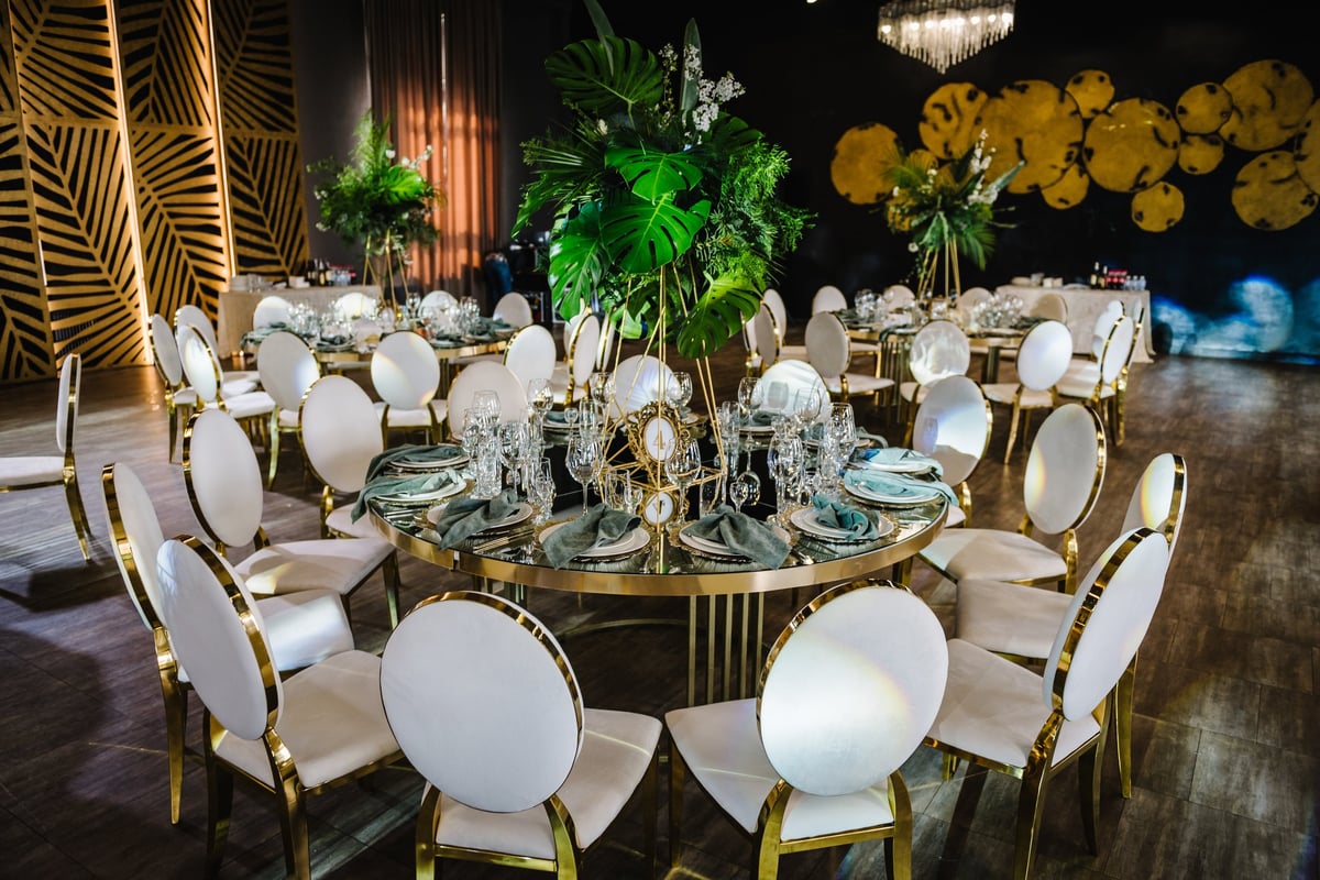 Elegant event decor with chandeliers and table settings