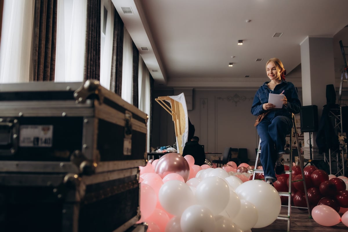 Event planner writing checklist for party decorations